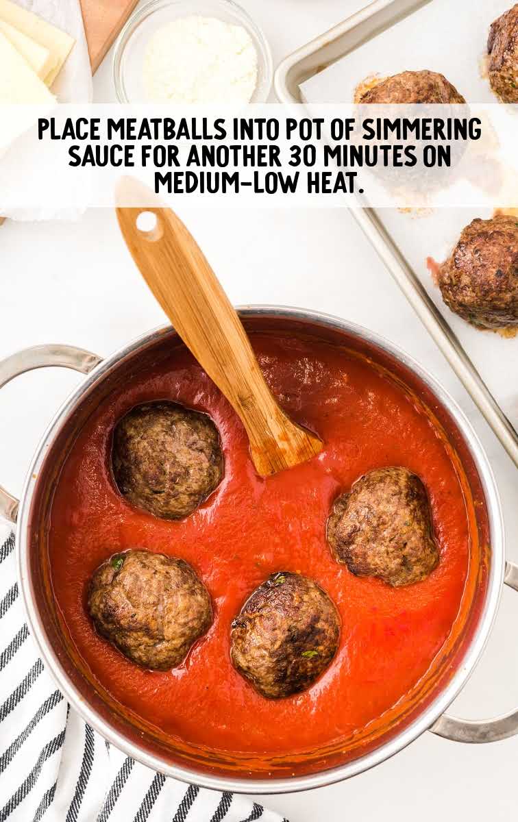 meatball subs process shot of meatballs in a pot of sauce