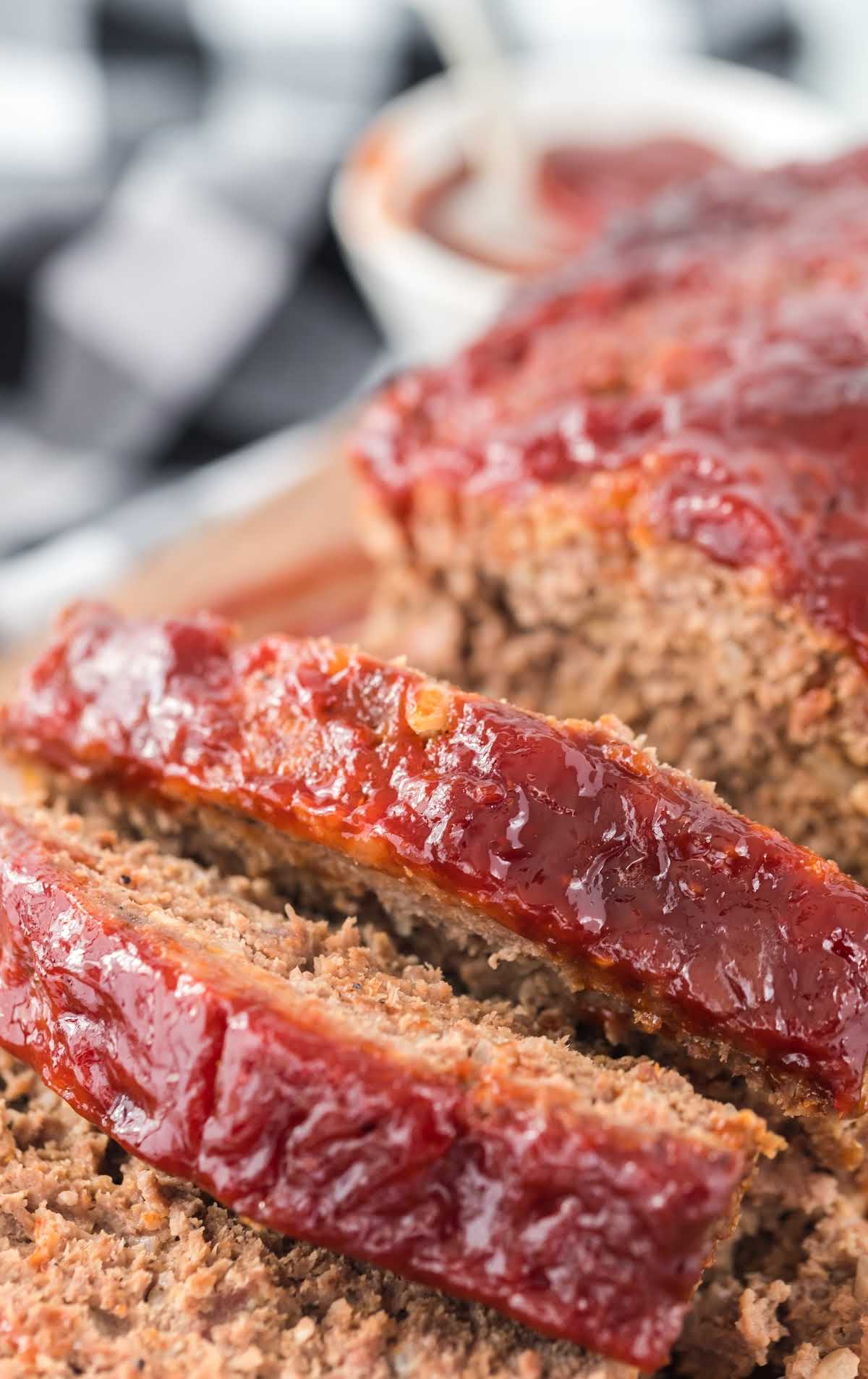 close up overhead shot of slices of meatloaf on a wooden board
