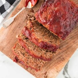 close up overhead shot of slices of meatloaf on a wooden board