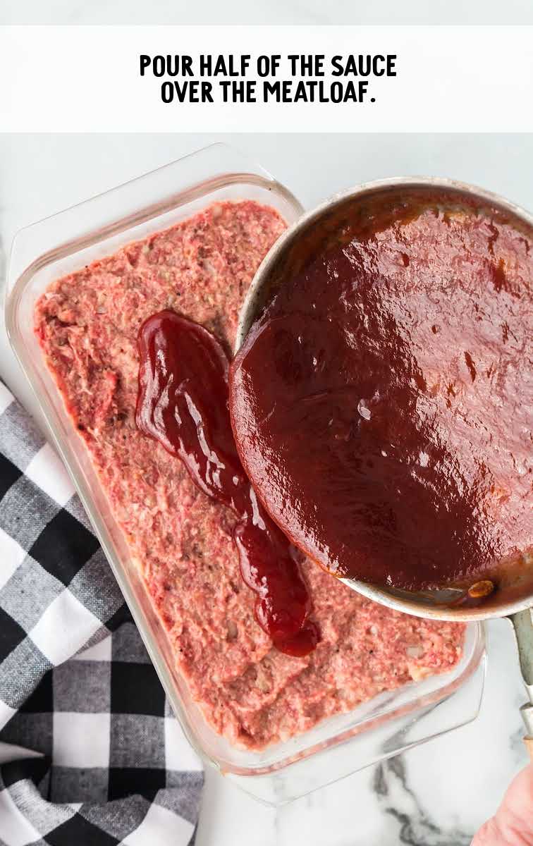 sauce being poured on top of meatloaf