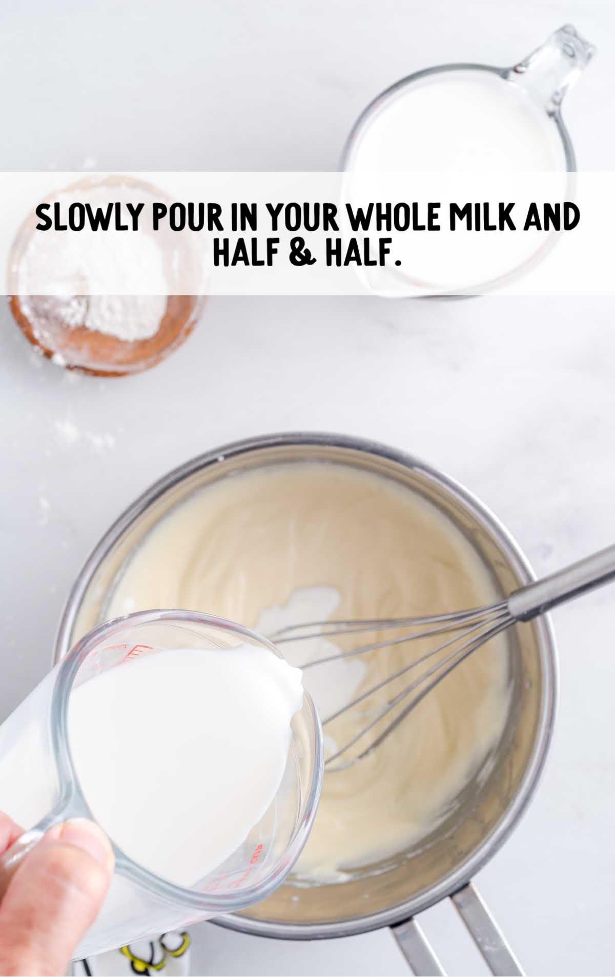 whole milk and half and half being whisked together with the ingredients in a pot