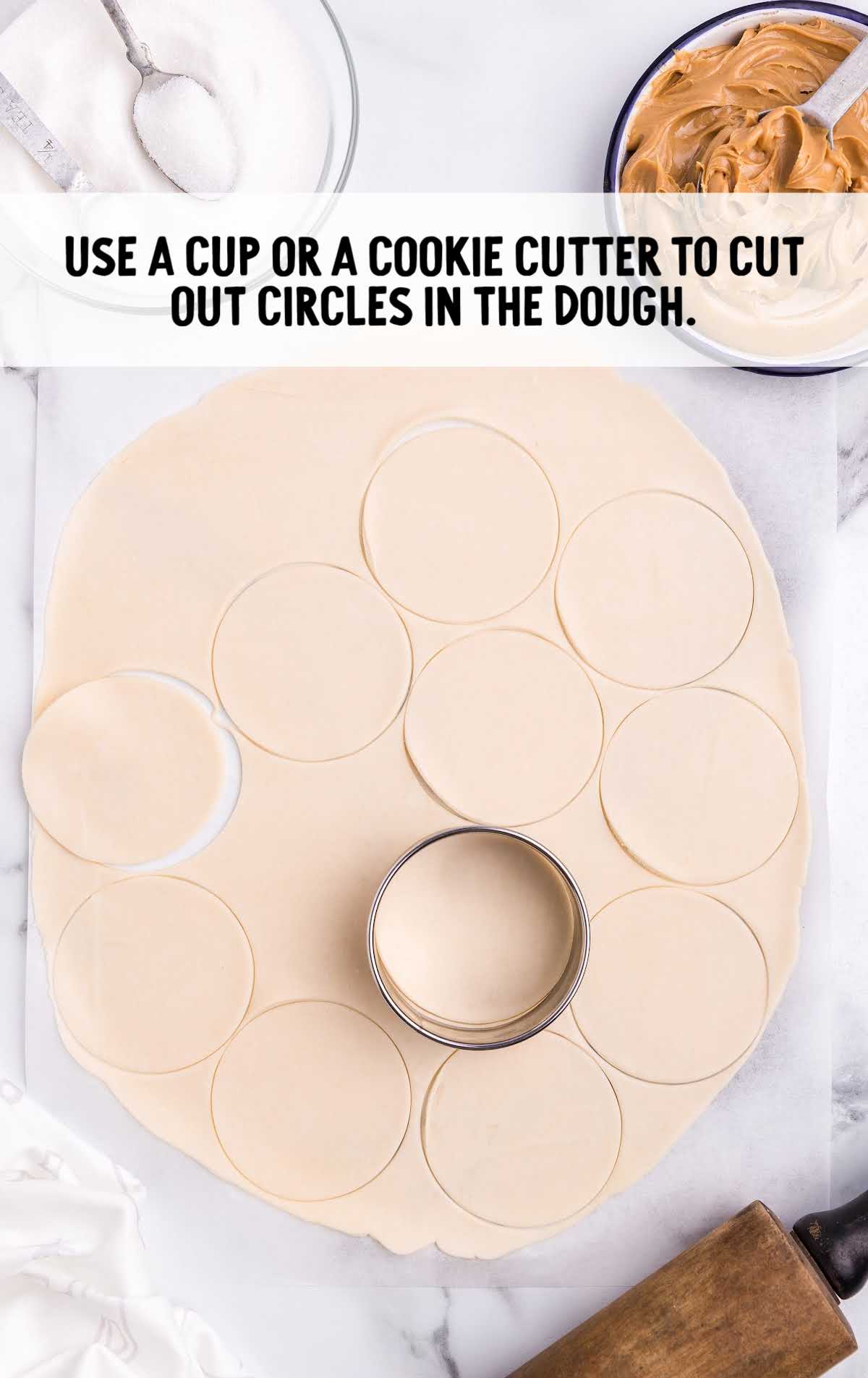 circles being cut out of dough with a cookie cutter
