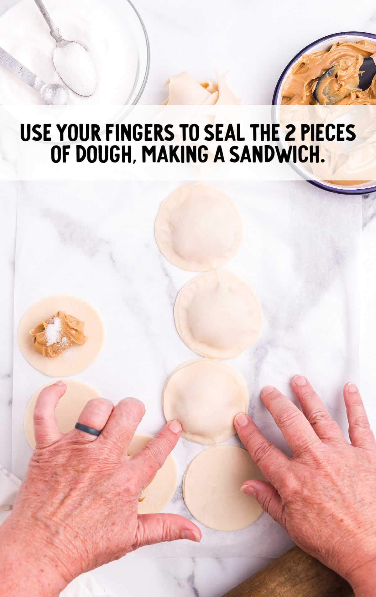 cookies being sealed with fingers