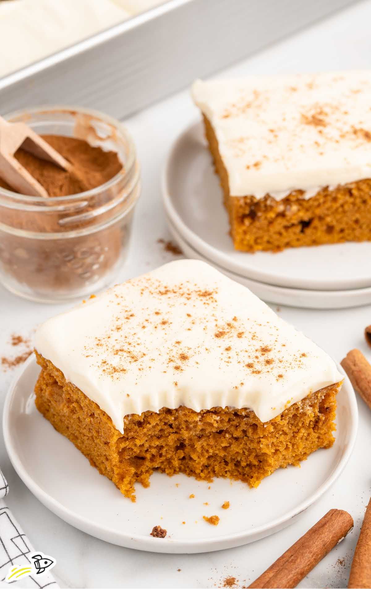 a slice of pumpkin bar sprinkled with cinnamon on a plate