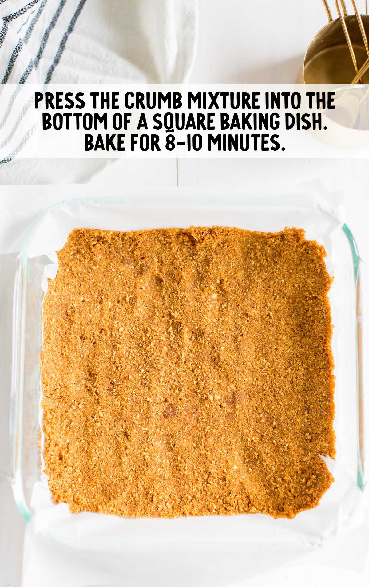 Graham cracker crust pressed into the bottom of a square baking dish before baking