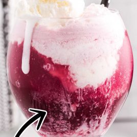 close up shot of a glass of Red Wine Floats with vanilla ice cream on top and a straw