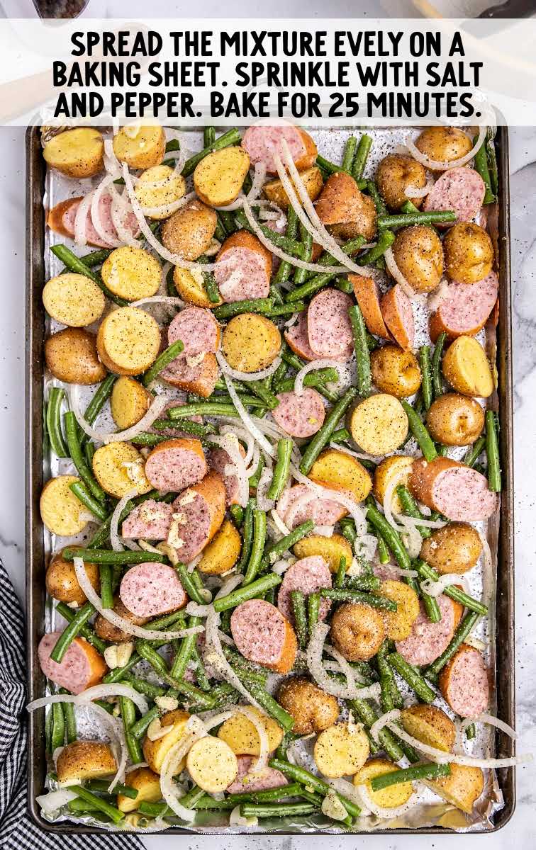 Sausage Green Bean Potato Casserole process shot of casserole spread in a baking sheet and topped with salt and pepper