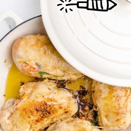 overhead shot of stuffed chicken breast in a pot with the lid
