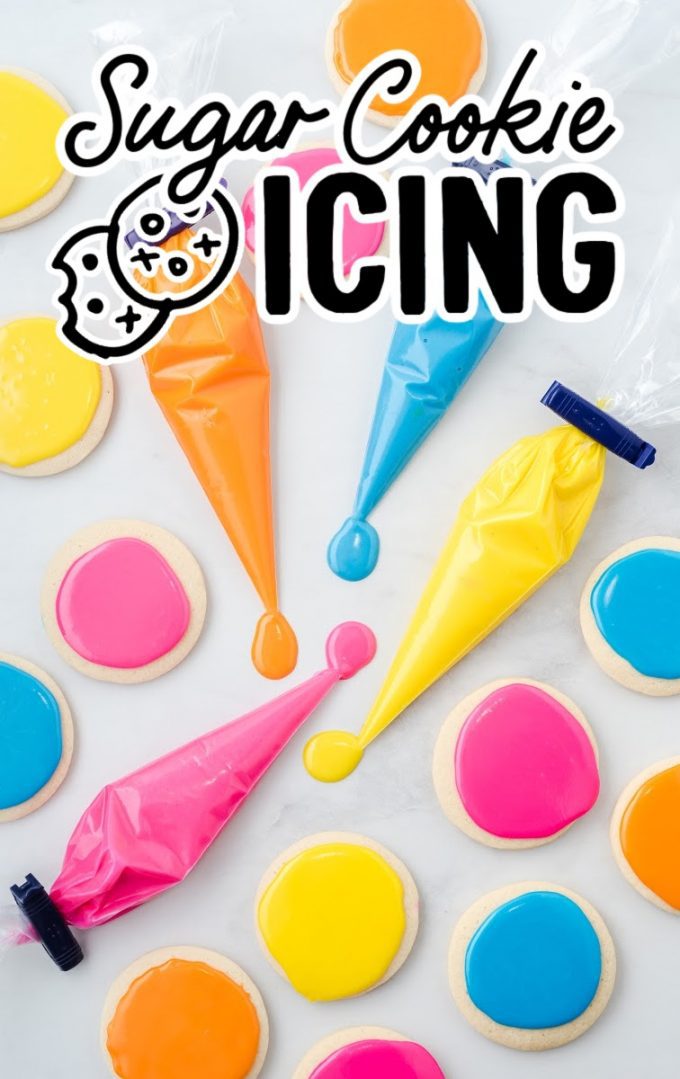 yellow, pink, blue, and orange icing in piping bags and also on top of sugar cookies
