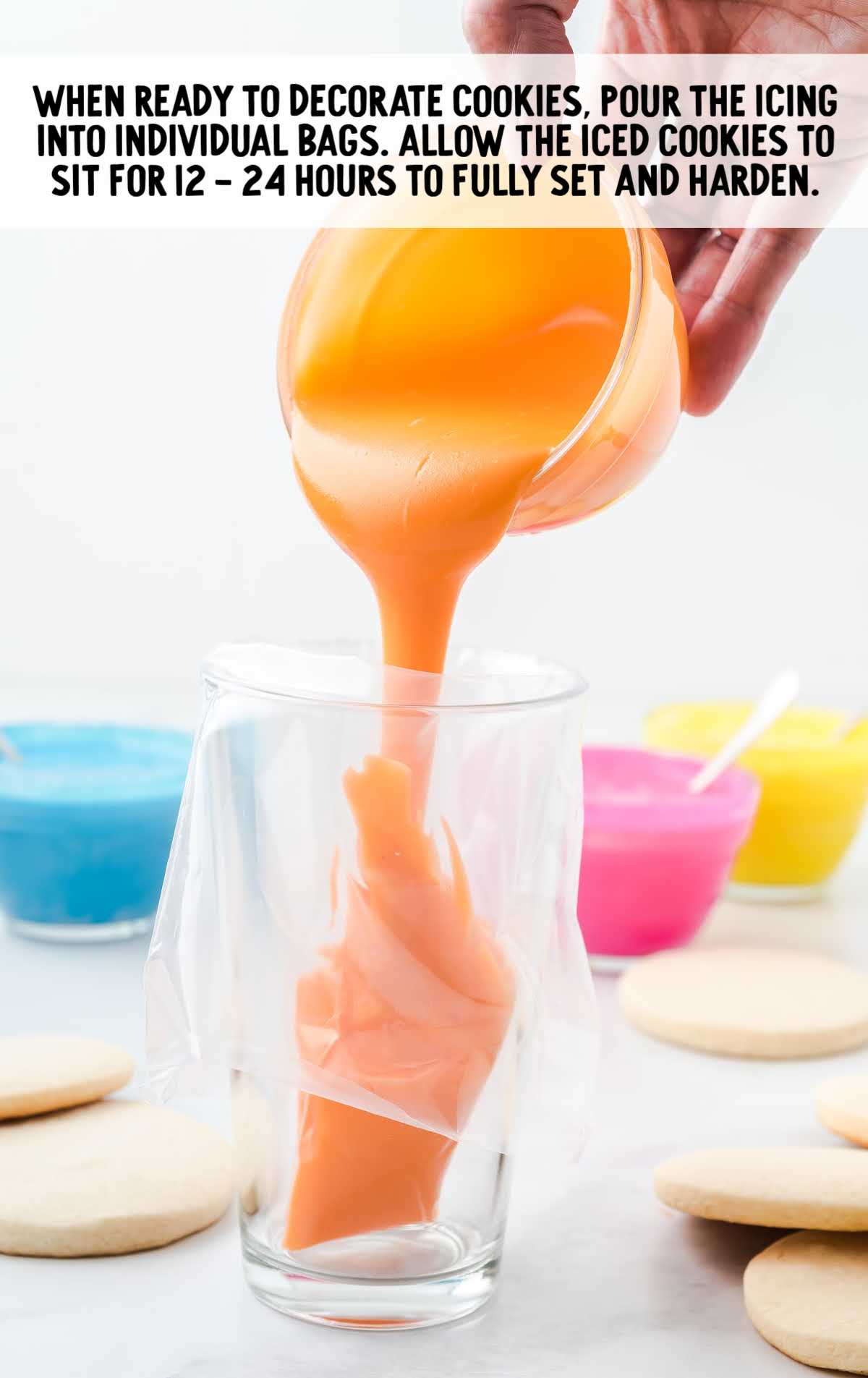 glass with a piping bag being filled with orange icing