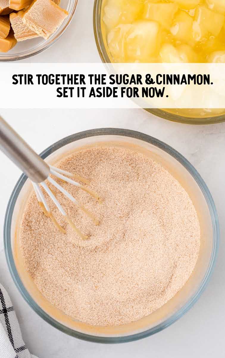 sugar and cinnamon being whisked together in a bowl