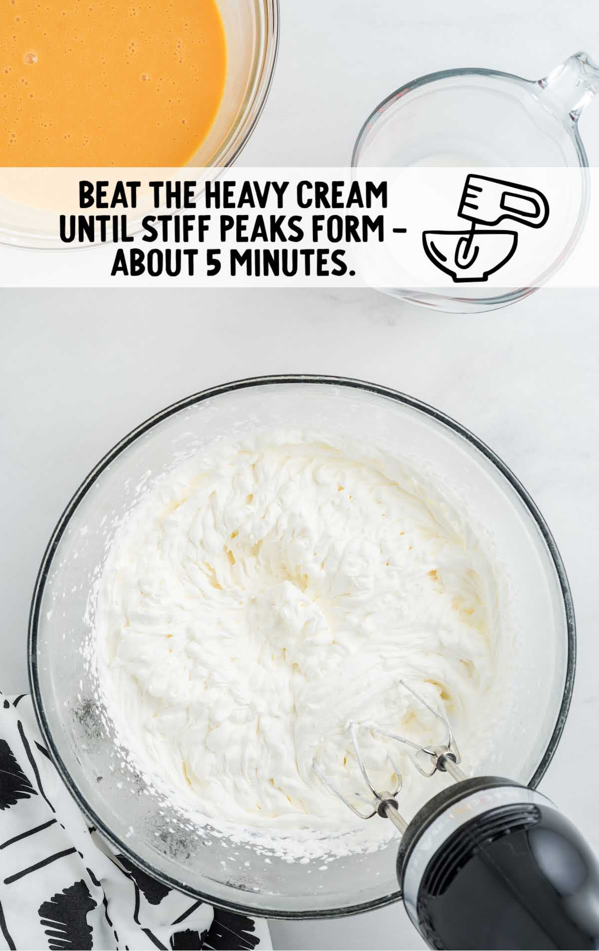 heavy cream being blended in a bowl