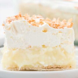 close up shot of coconut cream bars on a white plate