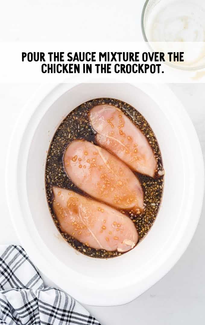 crockpot teriyaki chicken process shot of chicken and sauce in a crockpot