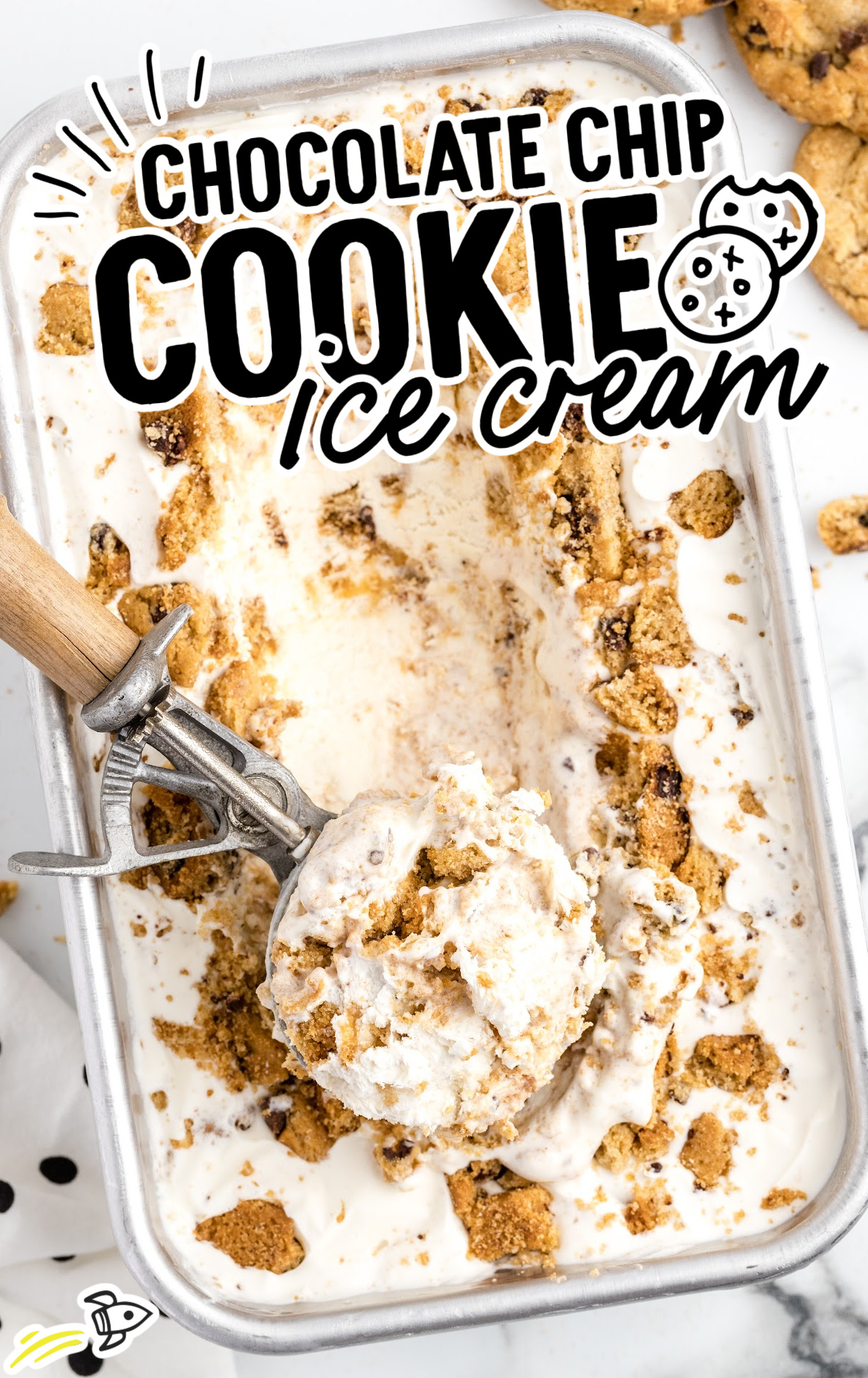 A tin of frozen chocolate chip cookie ice cream and an ice cream scoop is scooping out some of the ice cream. 