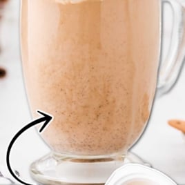 Tall glass of pumpkin spice latte with whipped cream labeled as the best ever pumpkin spice latte at home.