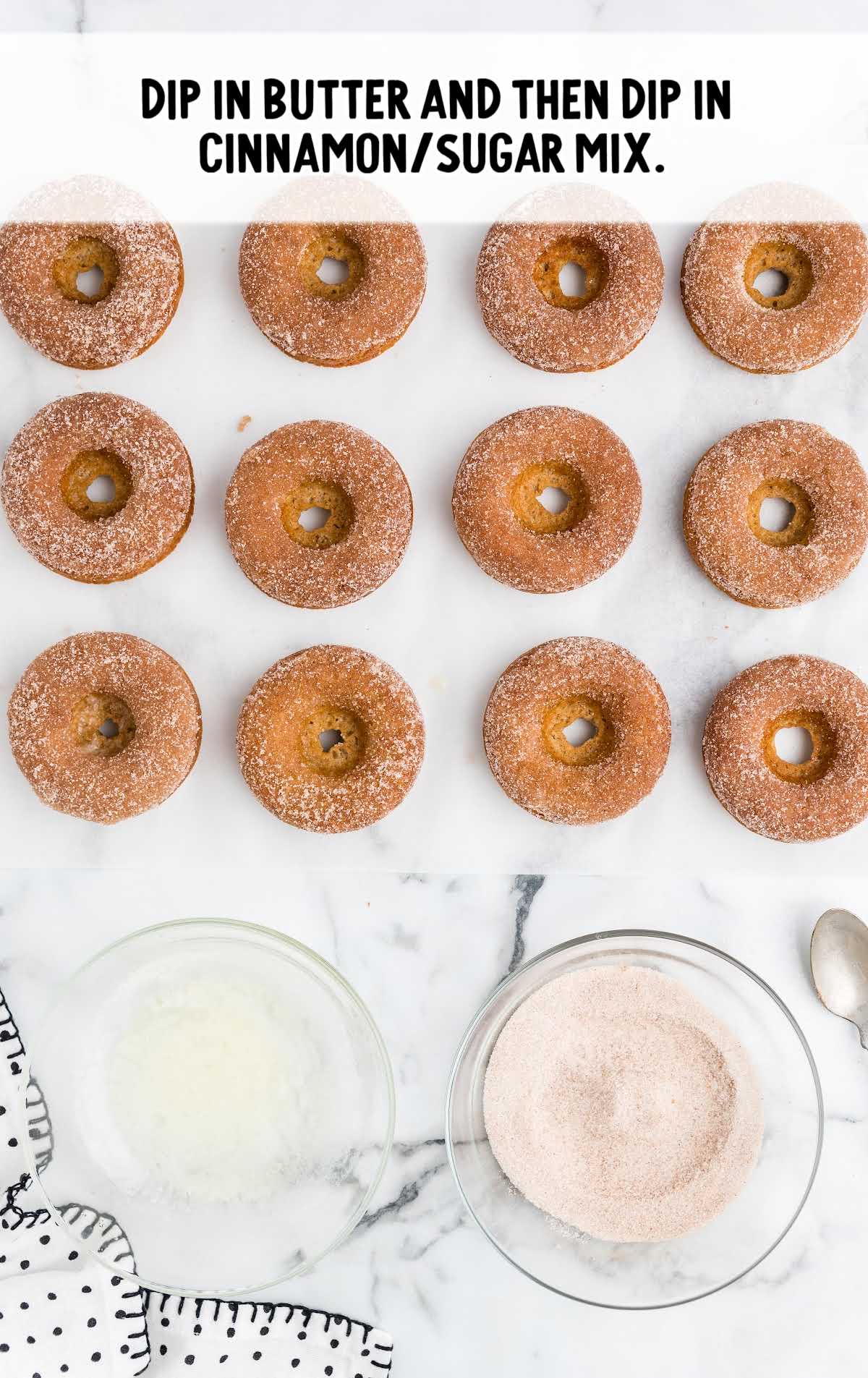 donuts dipped in cinnamon sugar frosting with a bowl of butter and the cinnamon sugar mixture