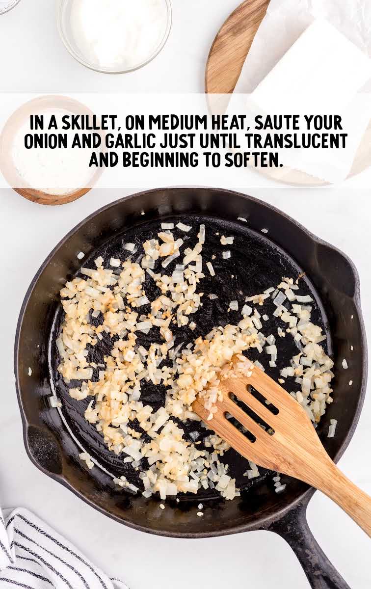 onion and garlic being sautéed in a skillet
