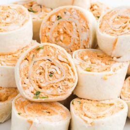 close up shot of Buffalo Chicken Pinwheels piled on top of each other