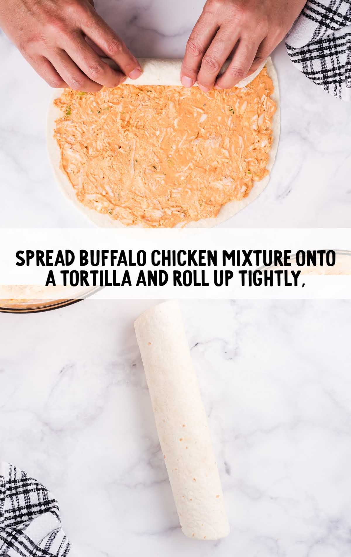 chicken being spread onto tortilla and then tightly rolled