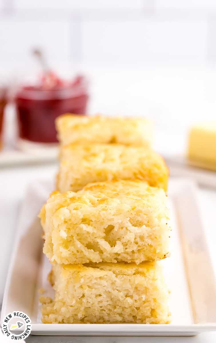 close up shot of butter swim biscuits piled on a plate