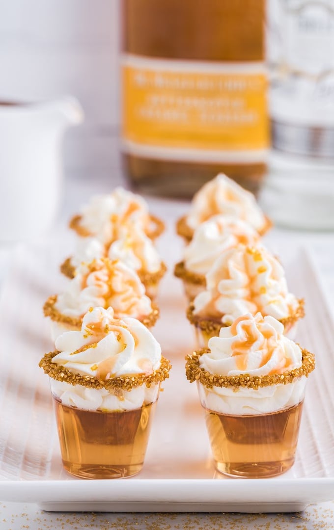 Eight Butterbeer Jello Shots on a white serving tray.