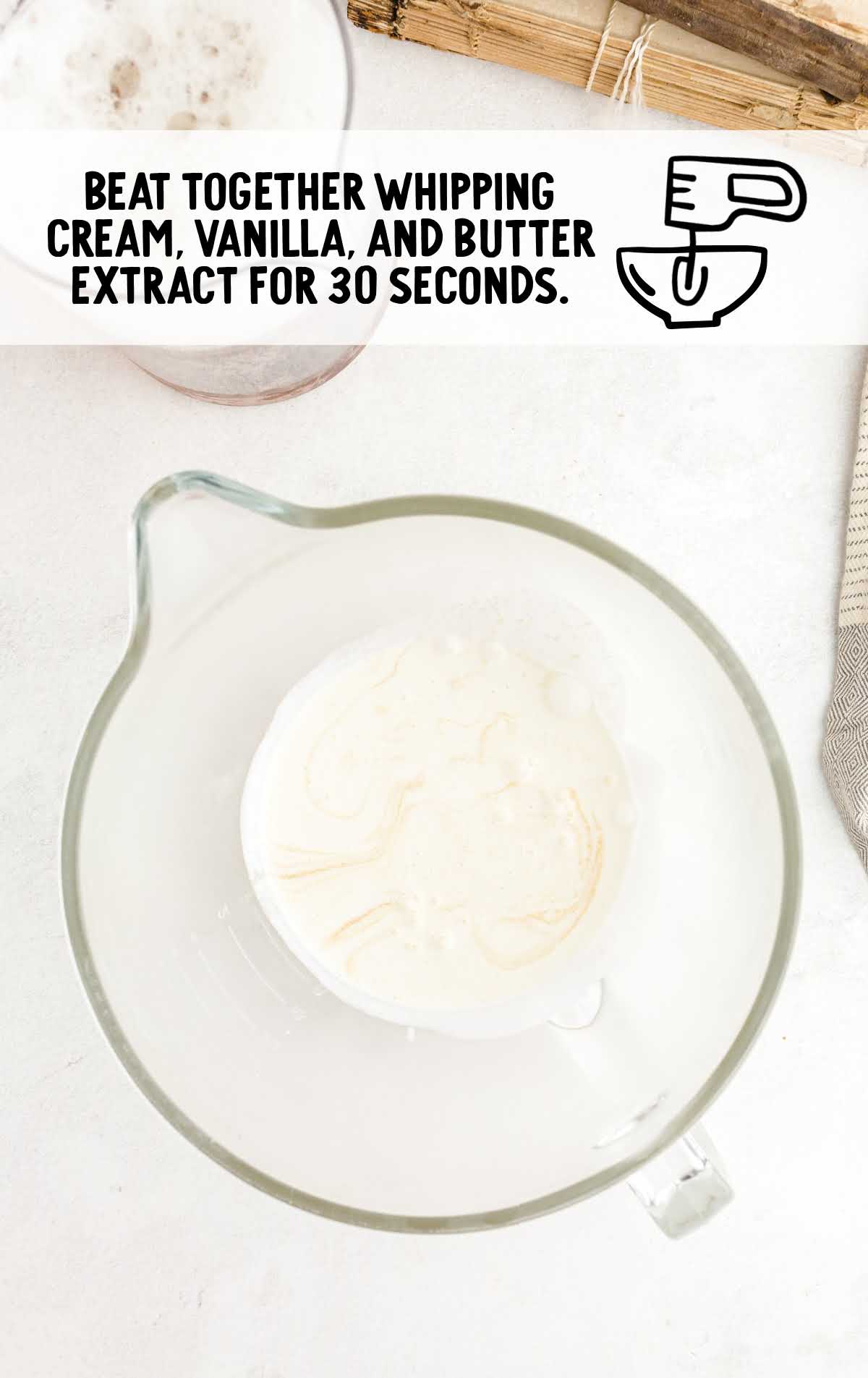 whipping cream, vanilla extract, and butter extract combined in a cup