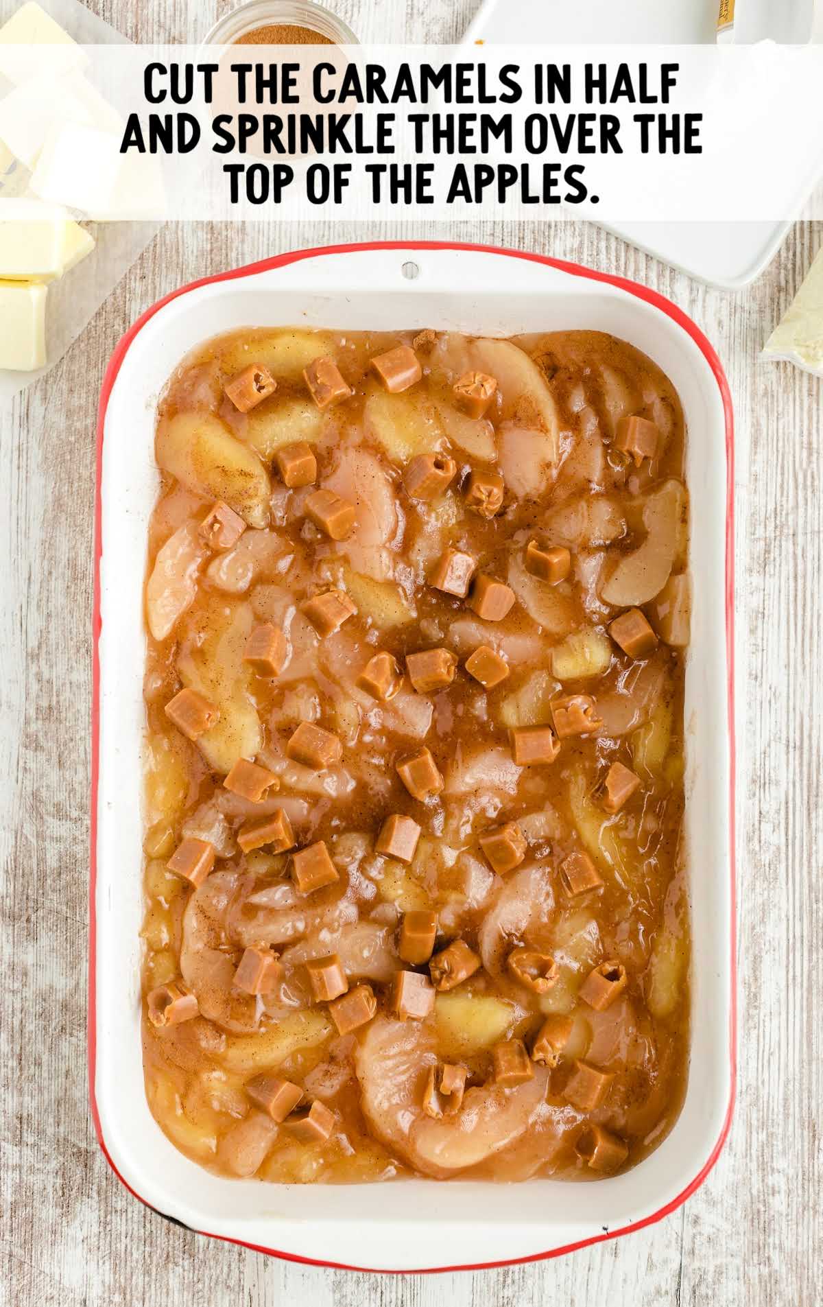 caramel being placed on top of apples in a baking dish