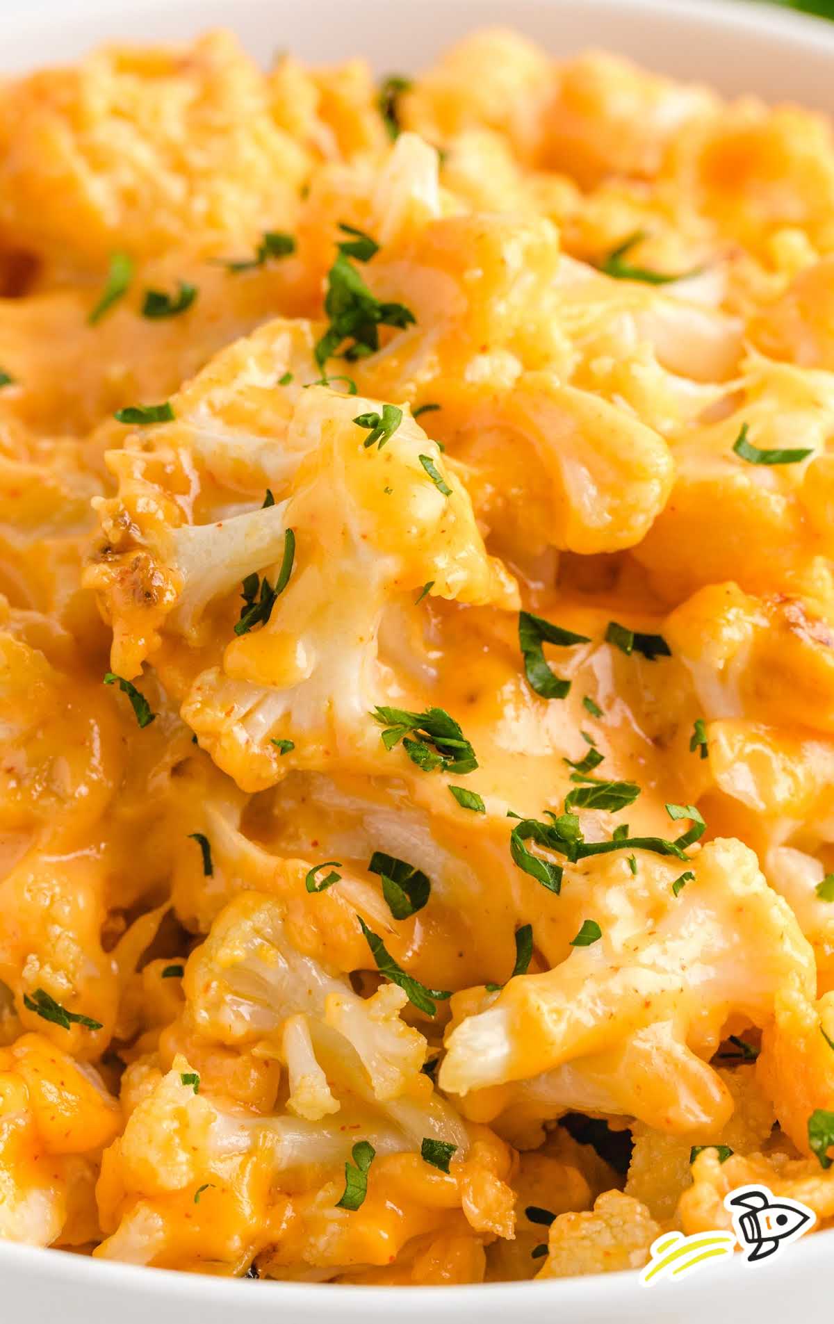 close up shot of a bowl of Cauliflower Mac and Cheese topped with parsley