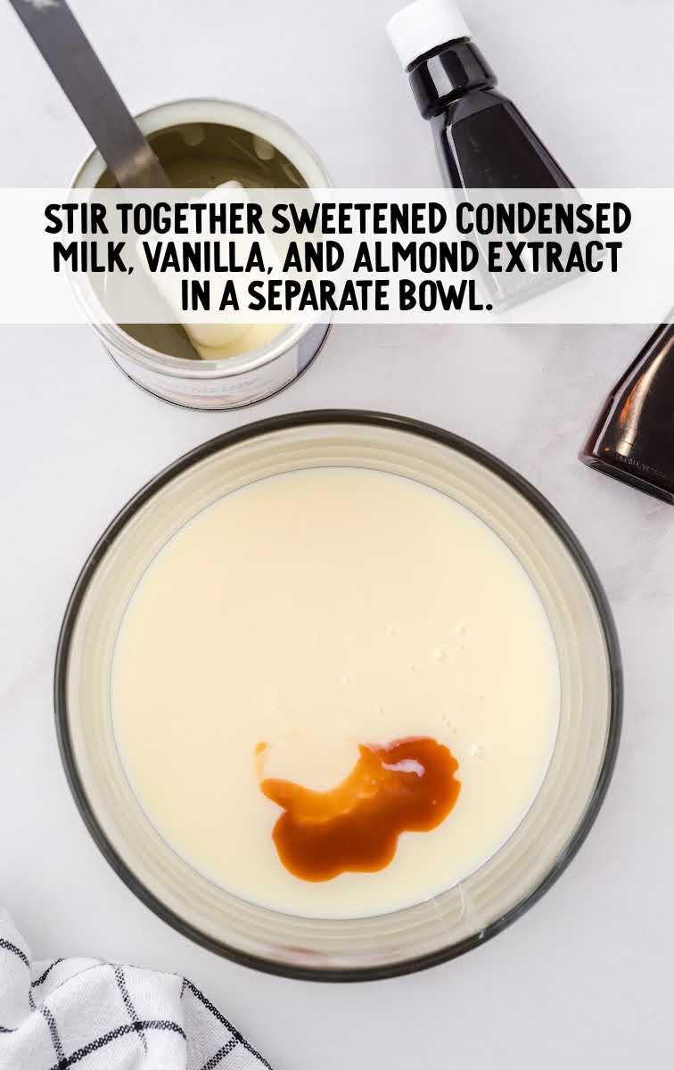 sweetened condensed milk, vanilla, and almond extract added to a bowl