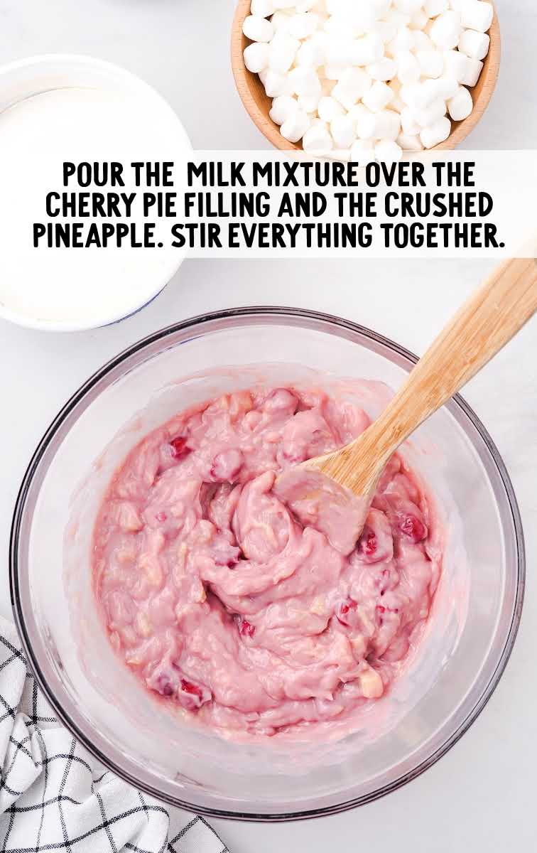 sweetened condensed milk mixture poured over the cherry pie filling and the crushed pineapple