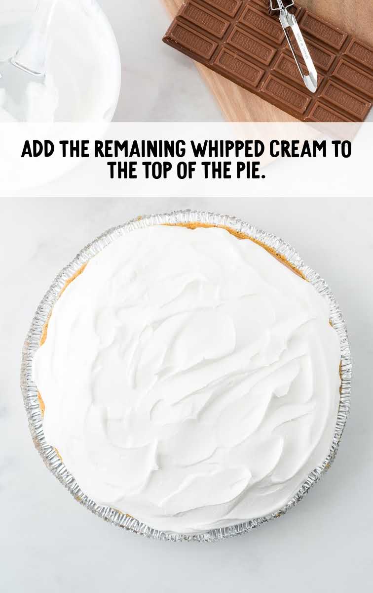 whipped cream being spread on top of pie