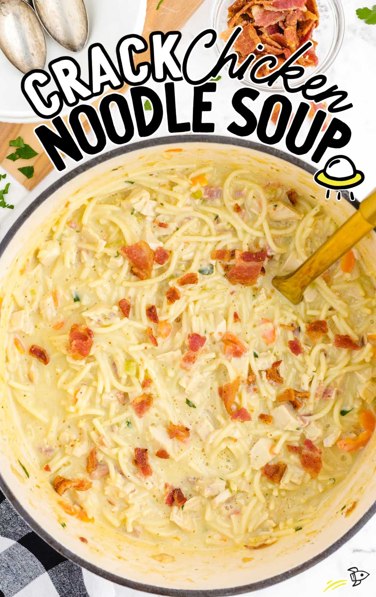 a pot of Chicken Noodle Soup with a large wooden spoon