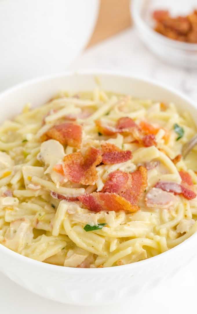 close up shot of a bowl of Crack Chicken Noodle Soup topped with bacon bites