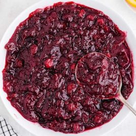 close up shot of a bowl of Cranberry Sauce with a spoon
