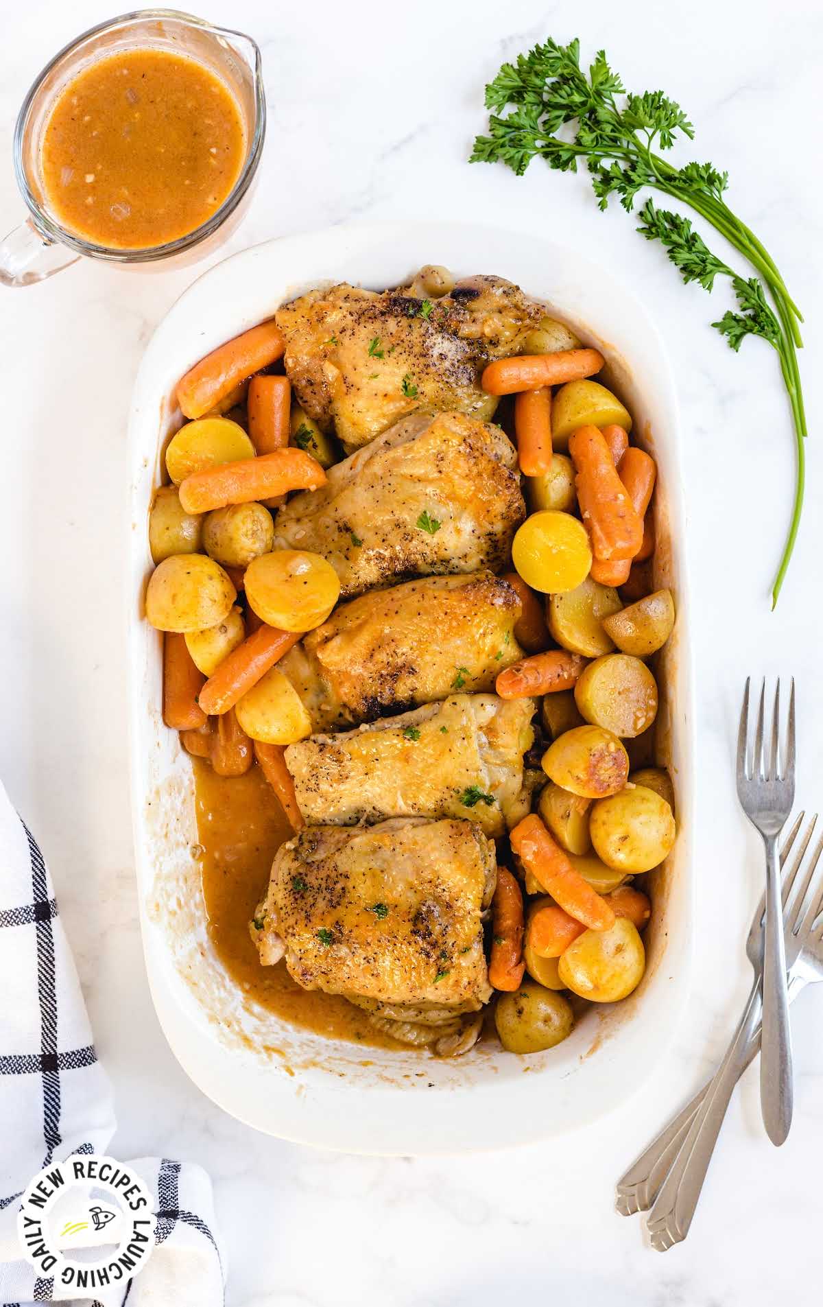 Close-up of shredded crockpot chicken in creamy sauce atop fluffy mashed potatoes.