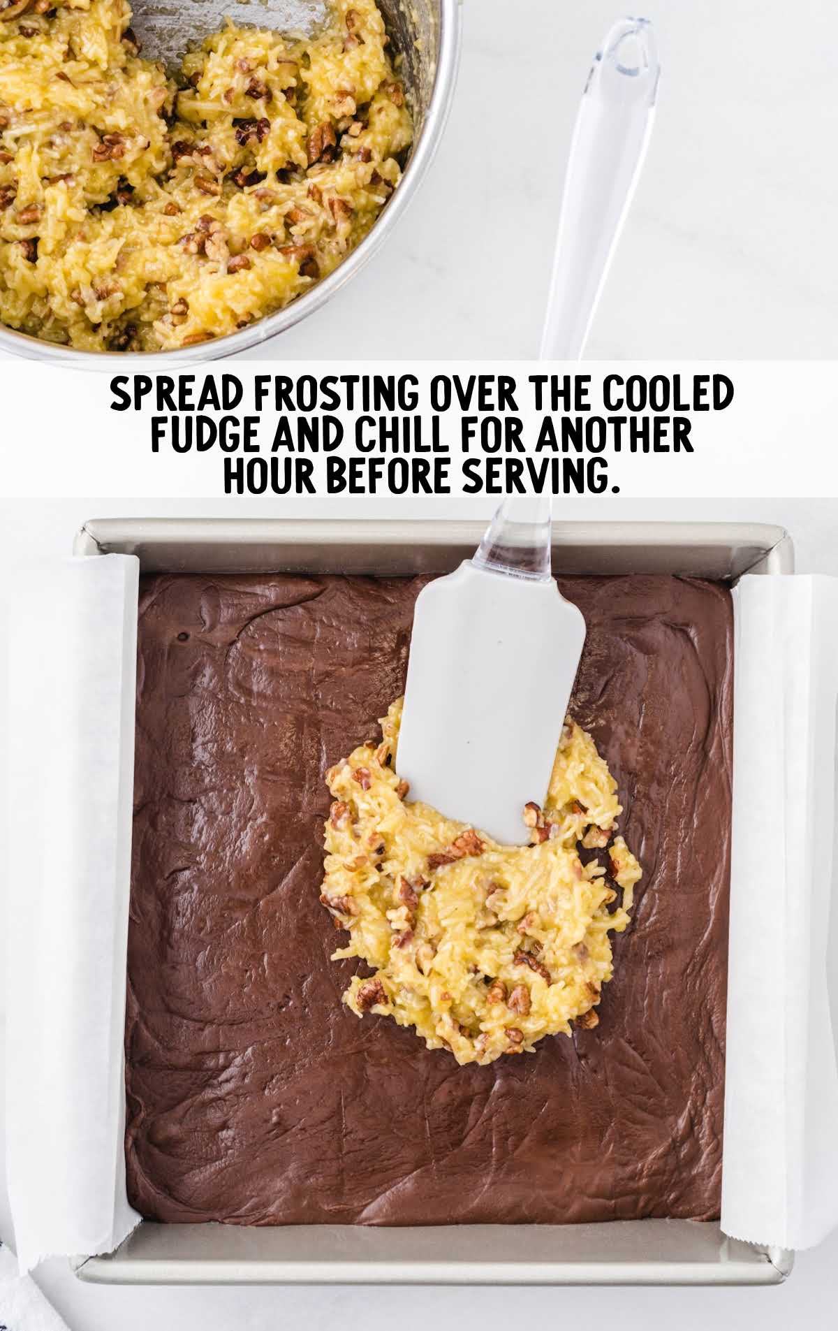 frosting being spread over fudge in a pan