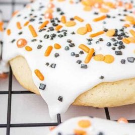 close up shot of Halloween Sugar Cookies topped with icing and sprinkles on a cooling rack