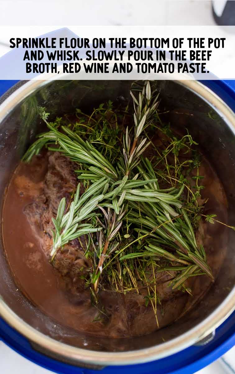 instant pot pot roast process shot of thyme and rosemary in a instant pot full of liquid