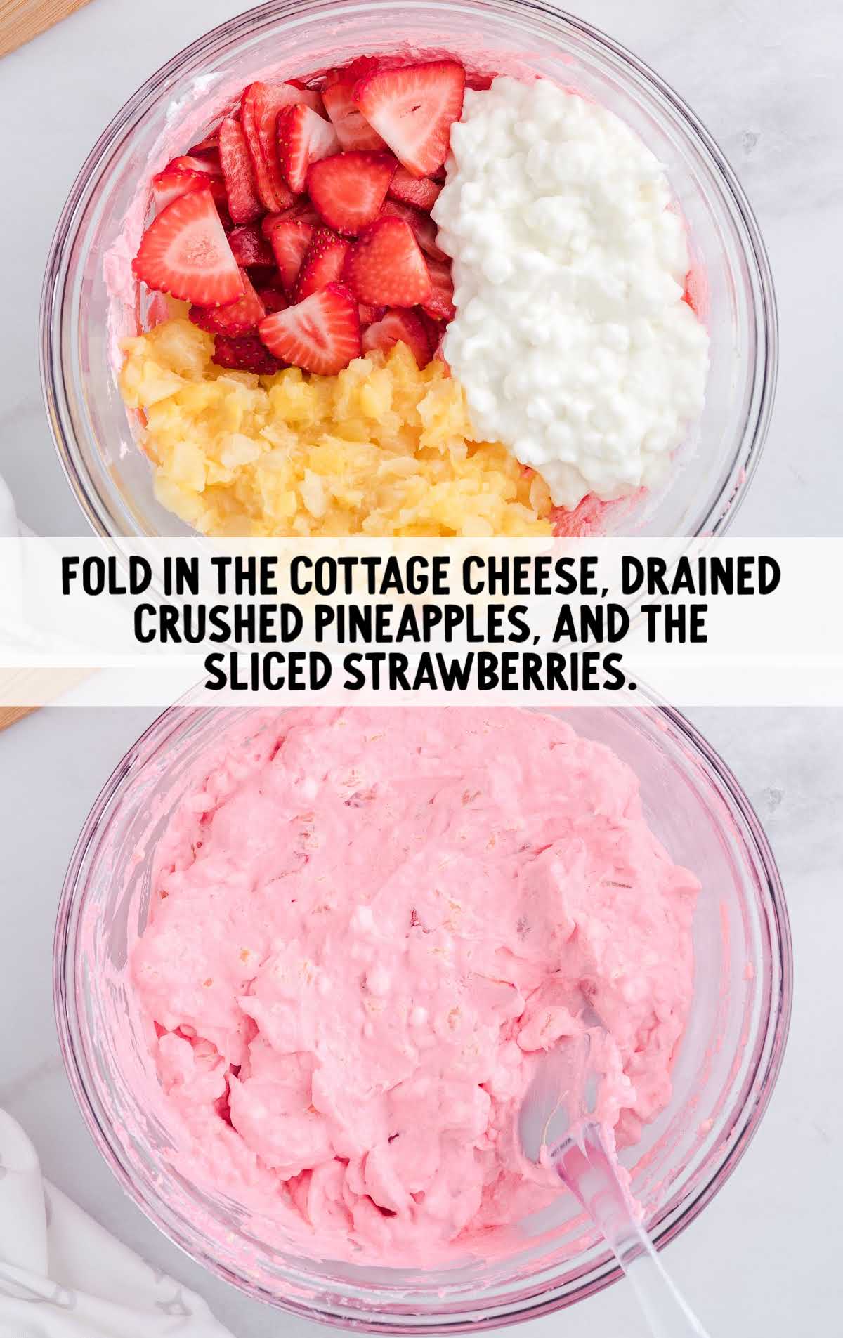 cottage cheese, crushed pineapples and sliced strawberries being folded together in a bowl