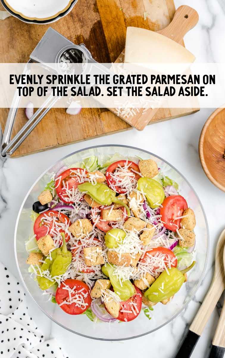 Olive Garden Salad Recipe process shot of grated parmesan sprinkled on top of salad