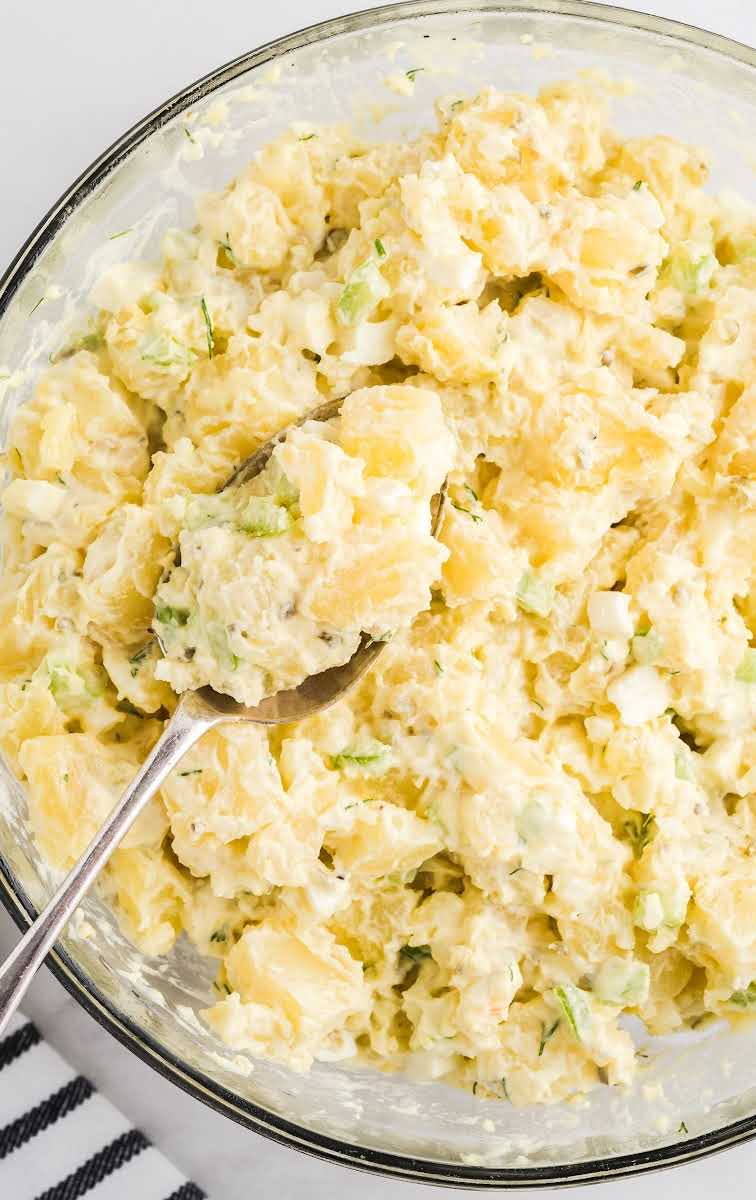 close up overhead shot of a bowl of Potato Salad with a spoon