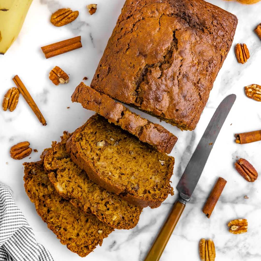 close up overhead shot of a loaf of Pumpkin Banana Bread with slices cut out