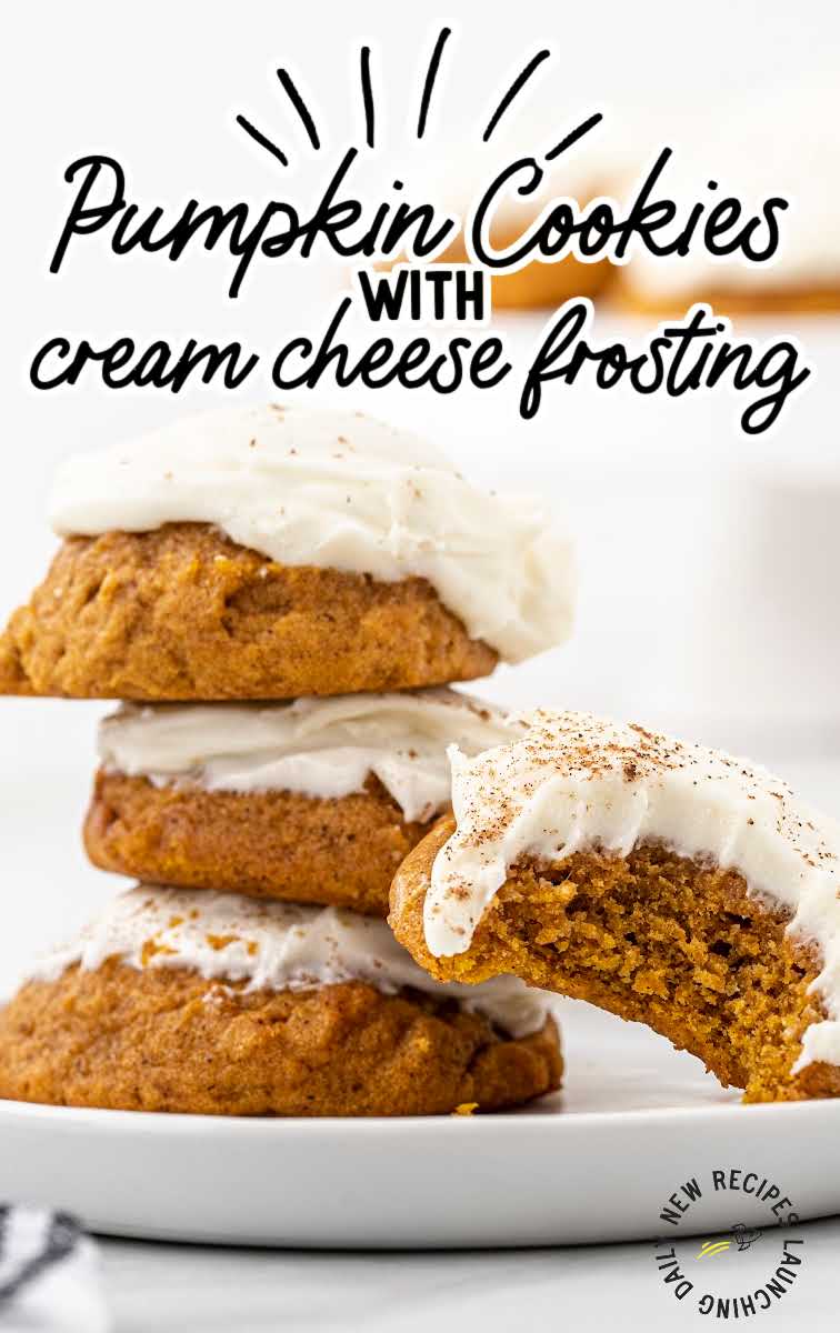 close up shot of Pumpkin Cookies with Cream Cheese Frosting sprinkled with cinnamon stacked on top of each other on a plate