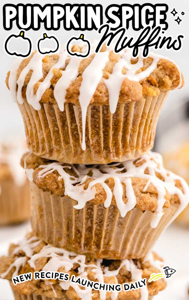 close up shot of Pumpkin Spice Muffins drizzled with icing stacked on top of each other