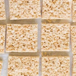 close up overhead shot of Rice Krispie Treats lined on top of parchment paper
