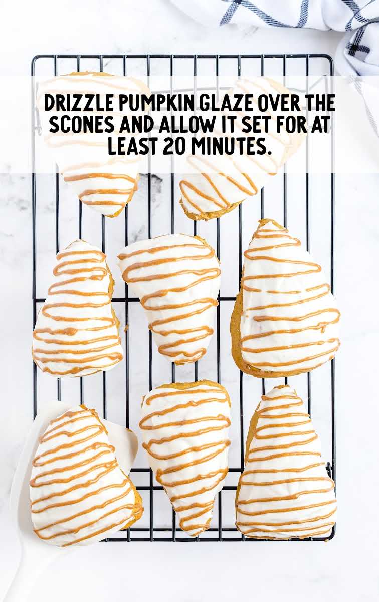 pumpkin scones drizzled with pumpkin glaze on a cooling rack