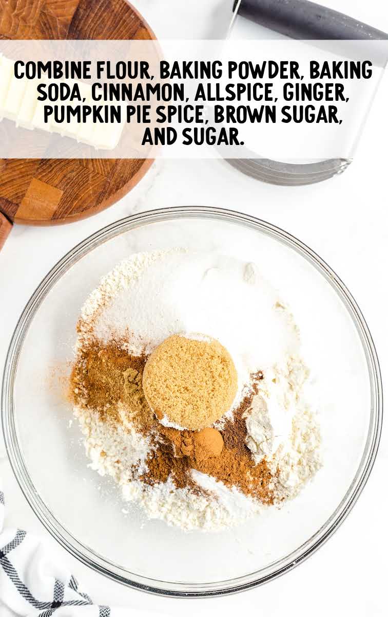 flour, baking powder, baking soda, cinnamon, all spice, ground ginger, pumpkin pie spice, light brown sugar, and granulated sugar combined in a bowl