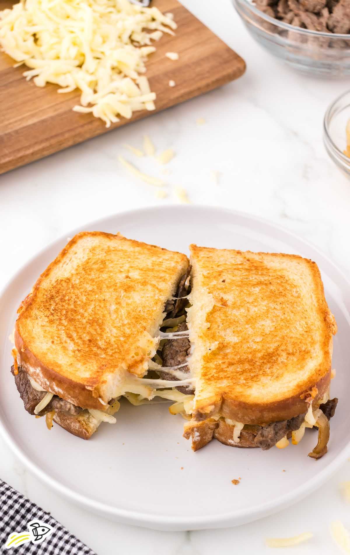 close up shot of a Steak Grilled Cheese sandwich on a plate