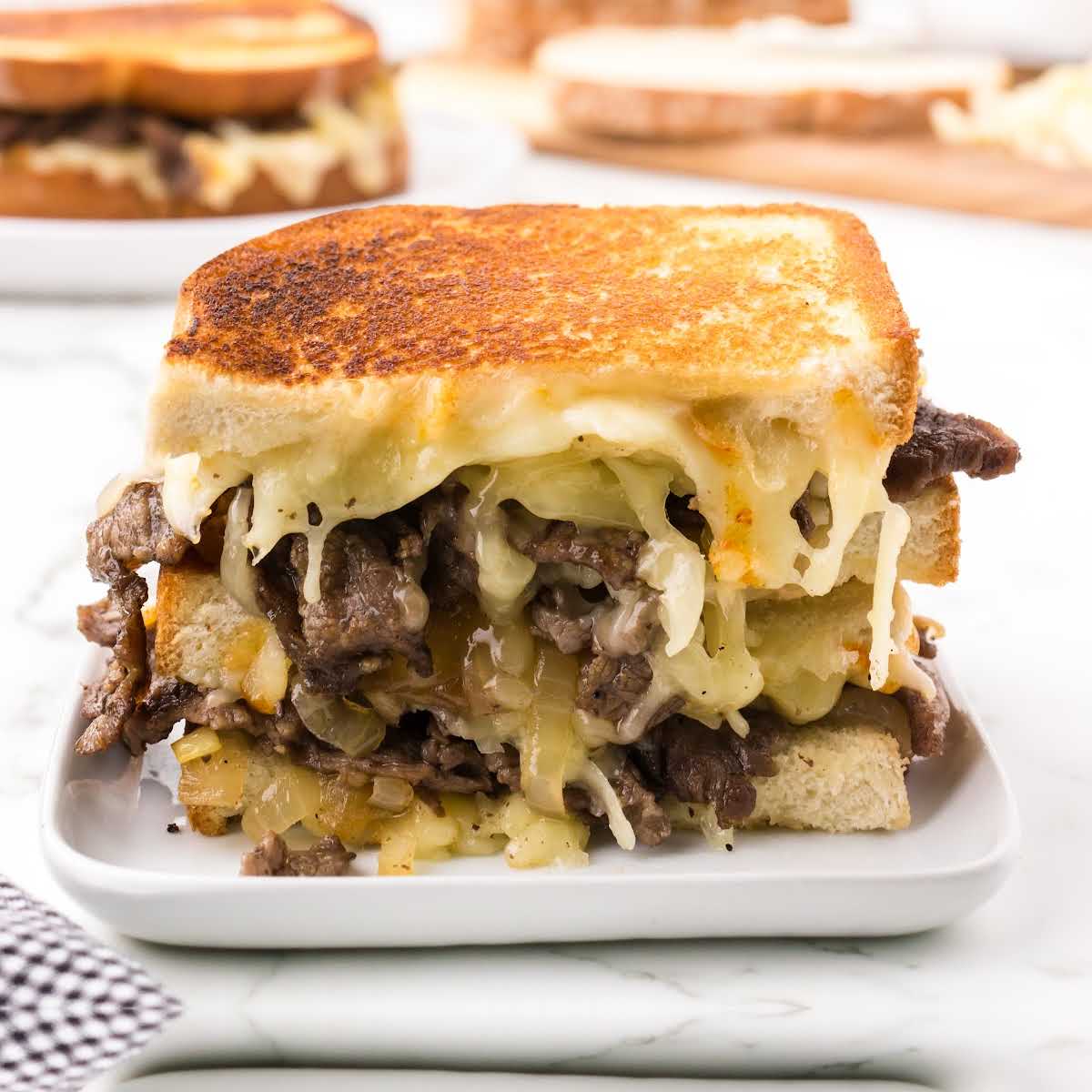 A sandwich sitting on top of a plate of food, with Cheese